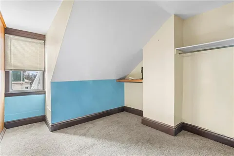 a room with furniture a flat screen tv and a window