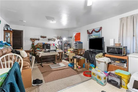 a bedroom with a bed ceiling fan and a window