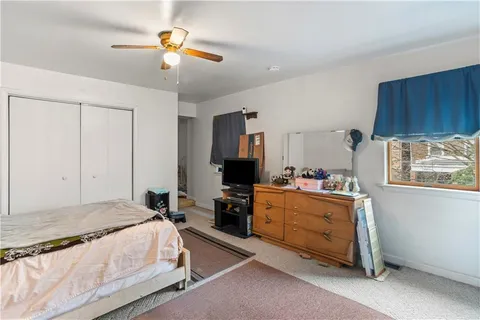 a bedroom with bed and a chandelier