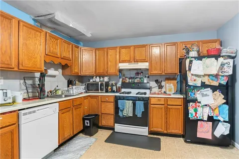 a kitchen with stainless steel appliances granite countertop a refrigerator and a stove top oven