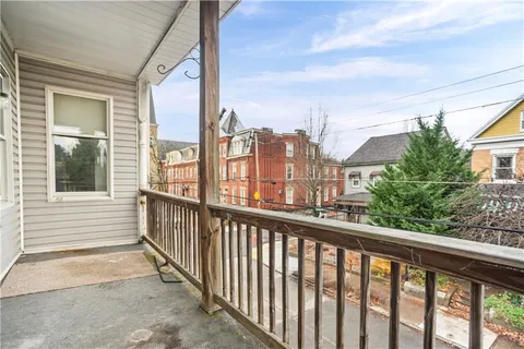 a open kitchen with stainless steel appliances granite countertop a stove a sink dishwasher and cabinets with wooden floor