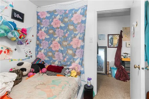 a bed sitting in a bedroom next to a window