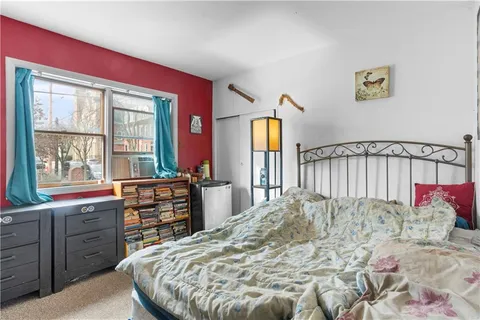 a bedroom that has a bed and a chair