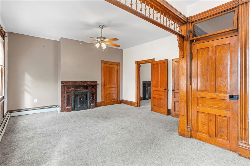 1524 Froman Street Pittsburgh, PA 15212 - Photo 8 of 48 a view of an empty room with a fireplace and a window