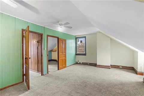 an empty room with windows & cabinet