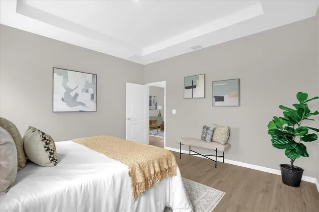 a bedroom with a bed and a potted plant