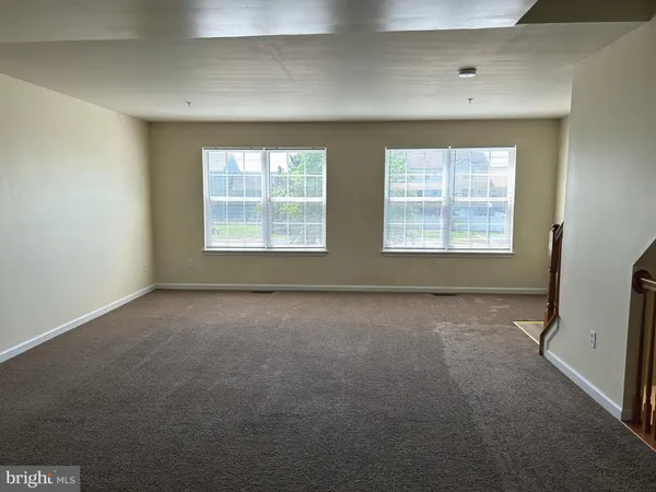 an empty room with a empty space and windows