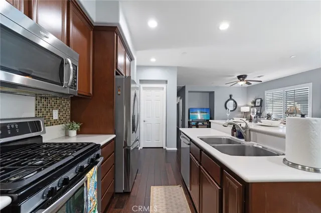 a kitchen with kitchen island a sink stove top oven and refrigerator