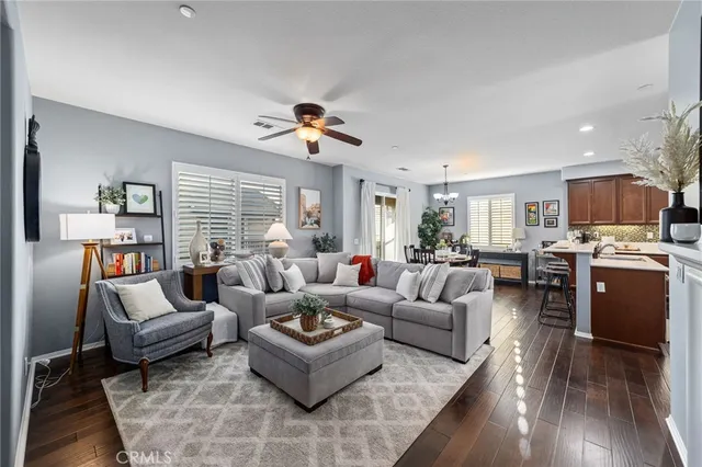 a living room with furniture fireplace and wooden floor