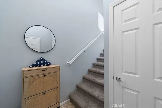 a room with a washing machine and a mirror