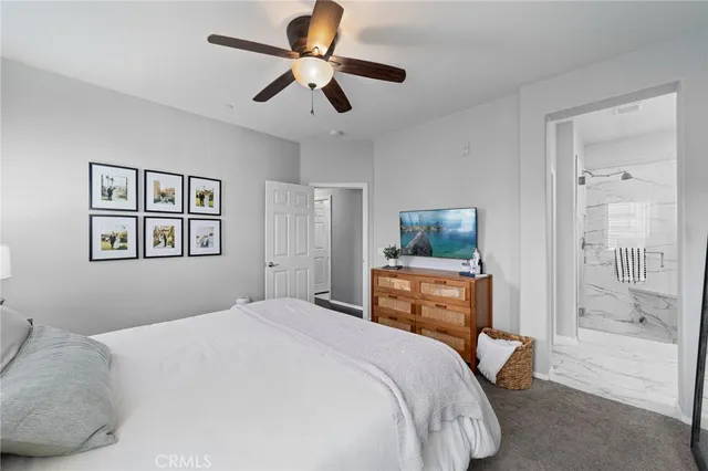 a bedroom with a large bed and a chandelier