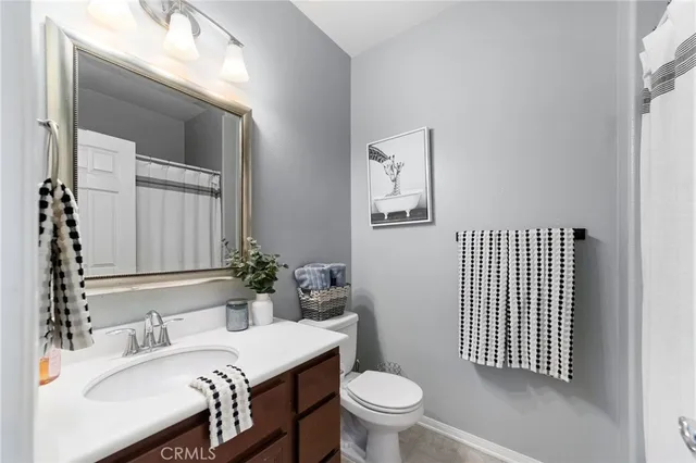 a bathroom with a sink toilet and mirror