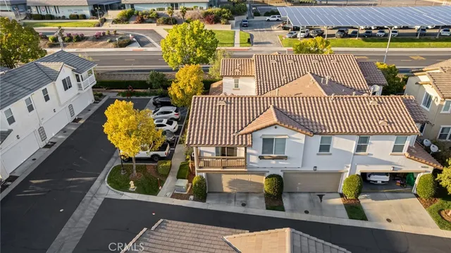 an aerial view of a house with garden space and signage