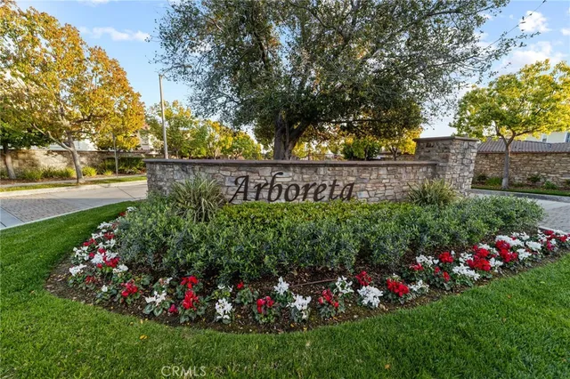 a view of a sign board with flower garden