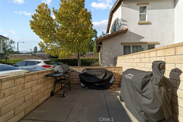a view of a patio with couches chairs and a fire pit