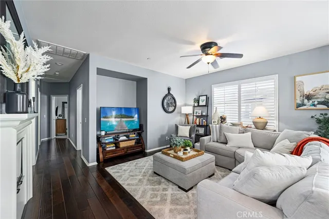 a living room with fireplace furniture and a flat screen tv