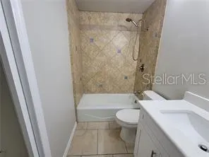 a white toilet sitting next to a bath tub