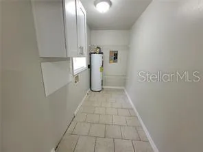a view of a storage & utility room with a sink