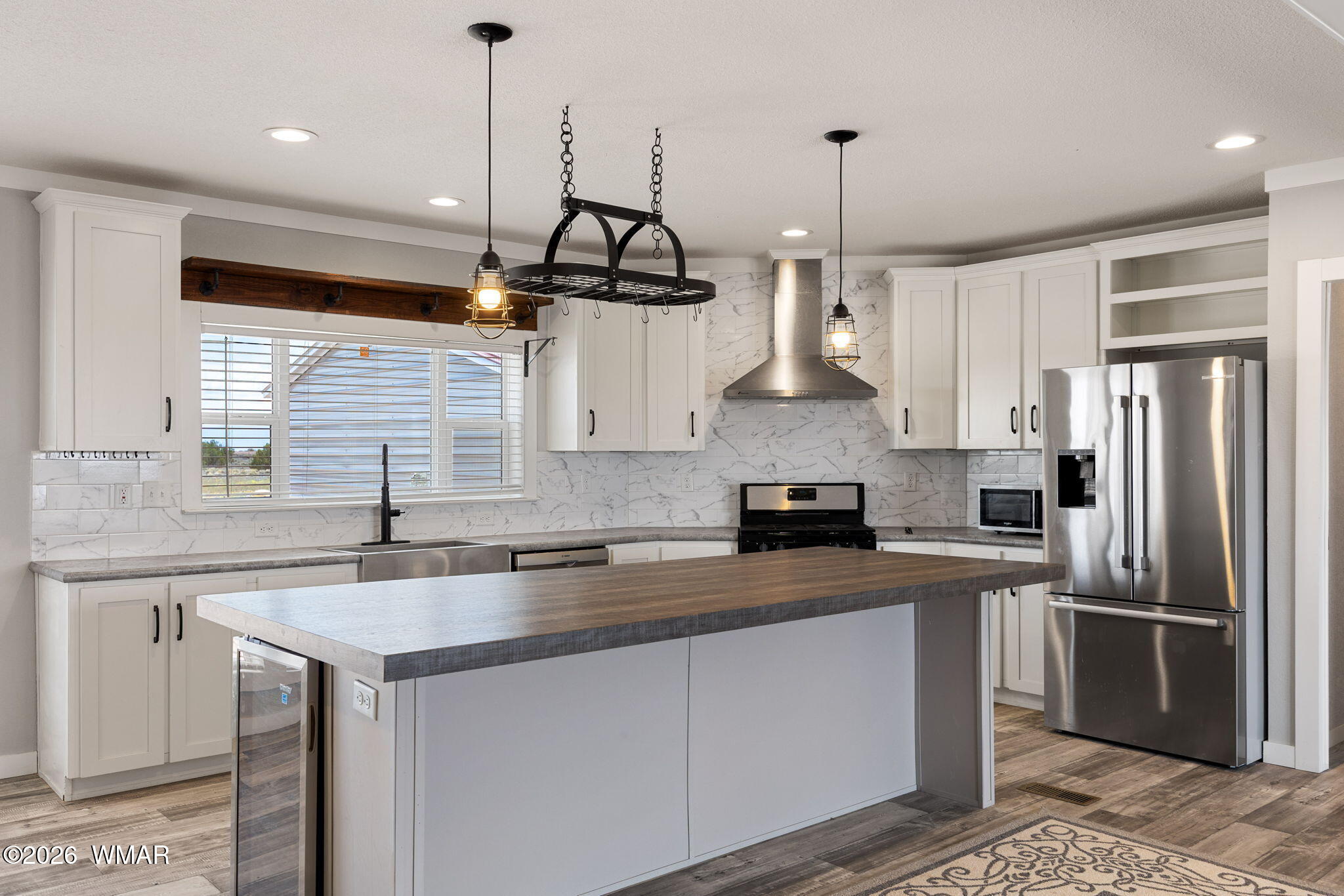 159 County Road St. Johns, AZ 85936 - Photo 11 of 59 a kitchen with stainless steel appliances granite countertop a sink a stove a refrigerator and island