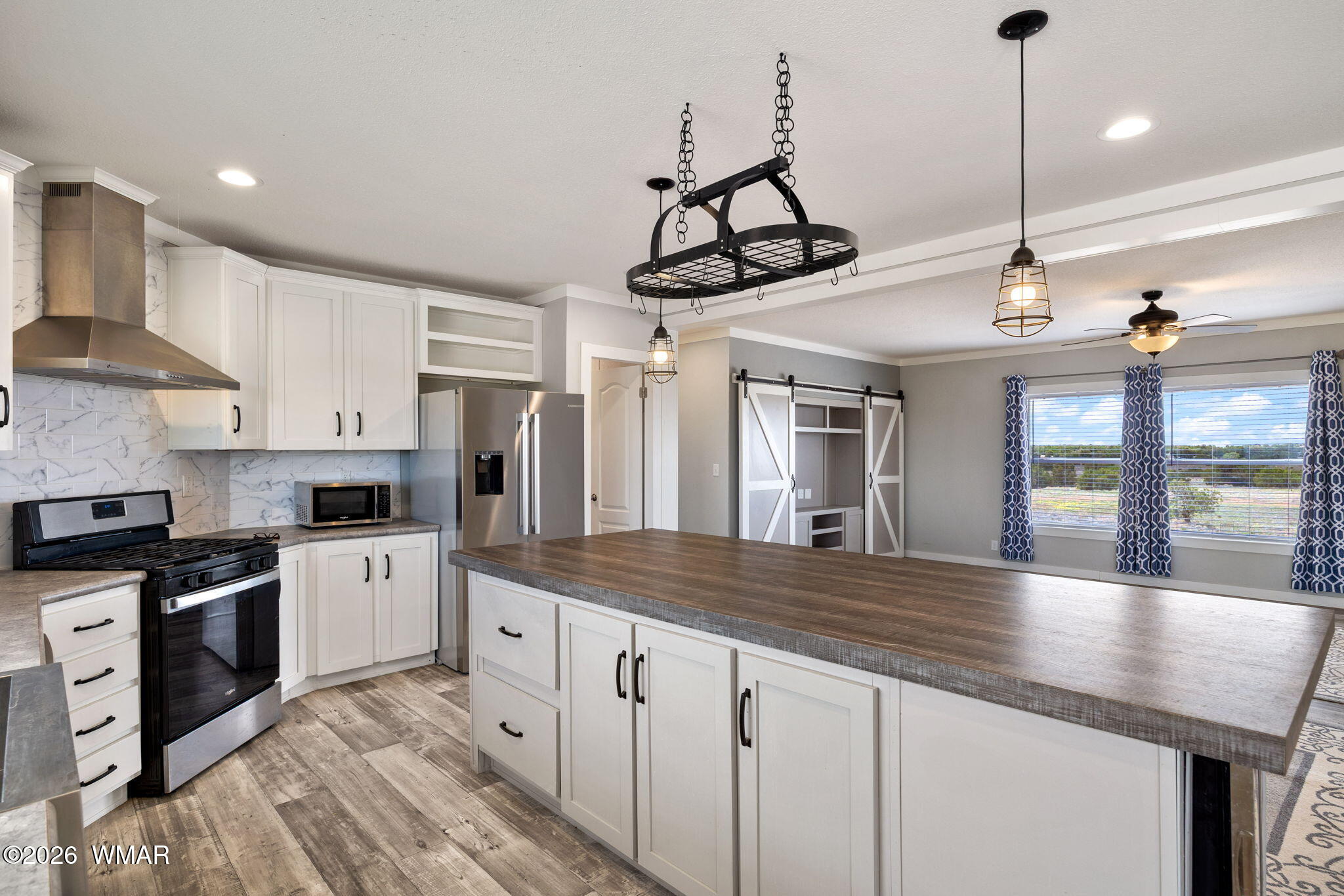 159 County Road St. Johns, AZ 85936 - Photo 12 of 59 a kitchen with stainless steel appliances granite countertop a sink a stove and a wooden floors