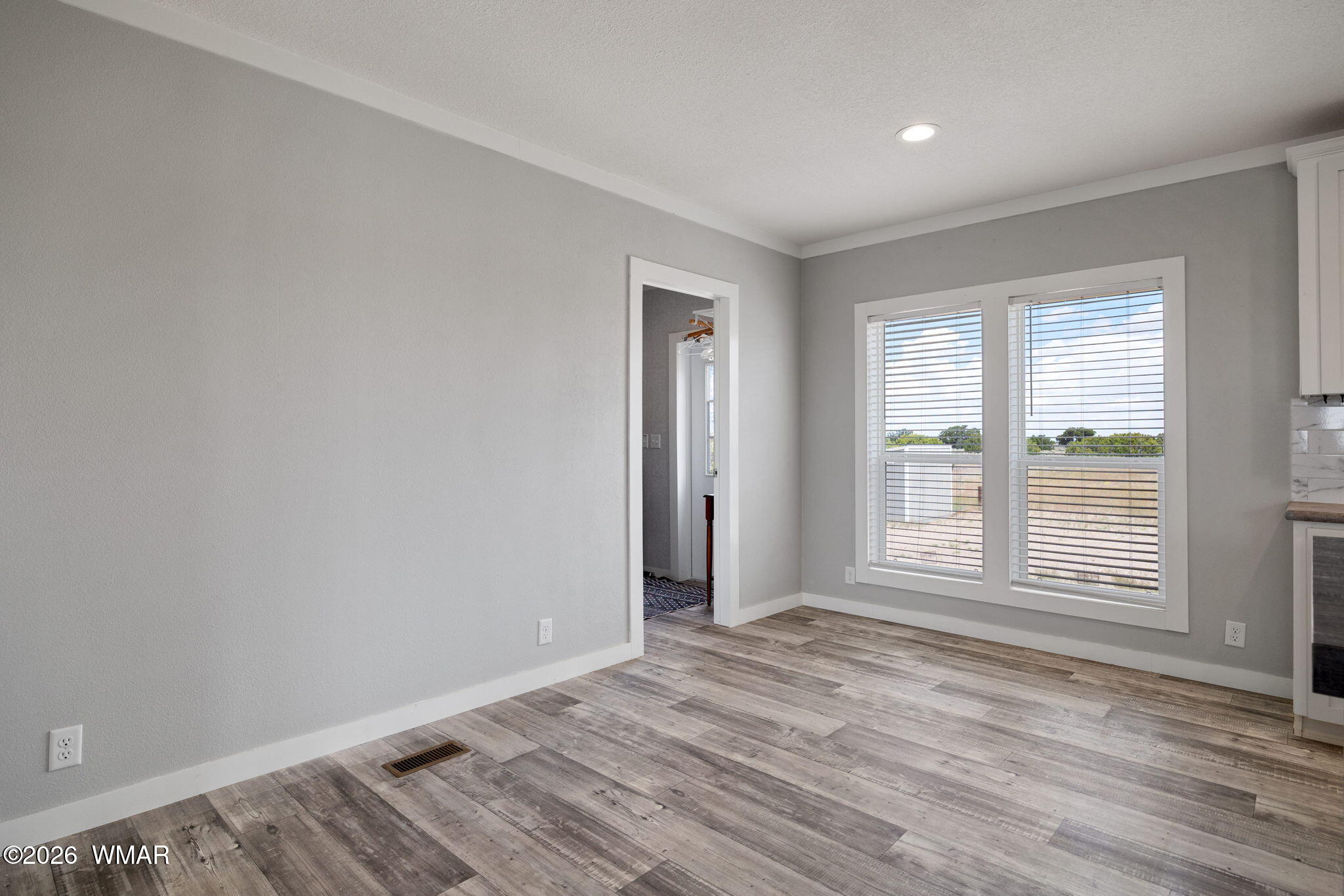 159 County Road St. Johns, AZ 85936 - Photo 15 of 59 an empty room with wooden floor and windows