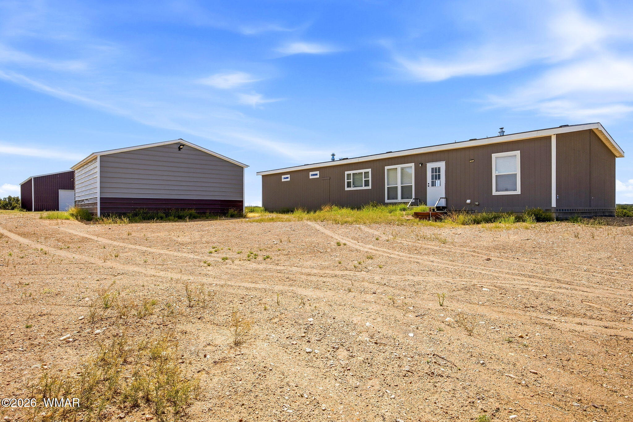 159 County Road St. Johns, AZ 85936 - Photo 37 of 59 a front view of house with yard and trees in the background