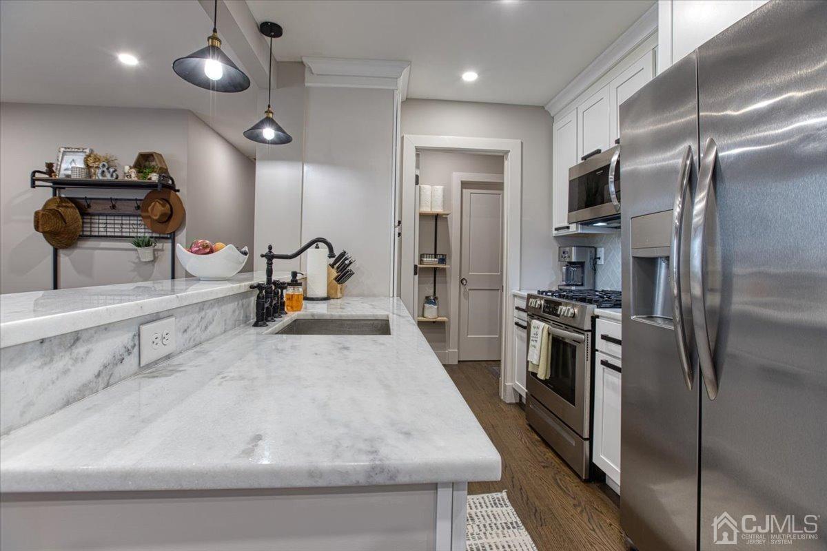 29 Clark Drive Howell, NJ 07731 - Photo 12 of 38 a kitchen with stainless steel appliances granite countertop a sink a stove and a refrigerator