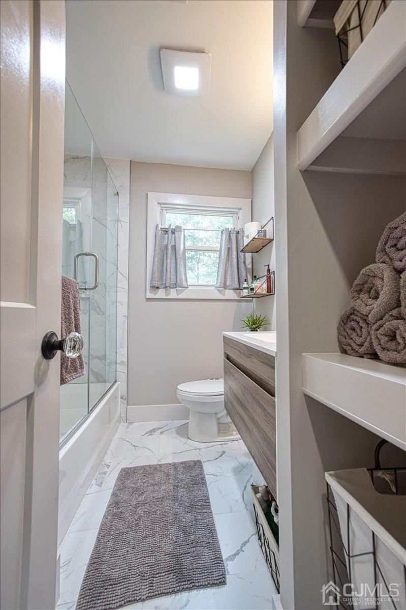 29 Clark Drive Howell, NJ 07731 - Photo 20 of 38 a bathroom with a sink a toilet and shower