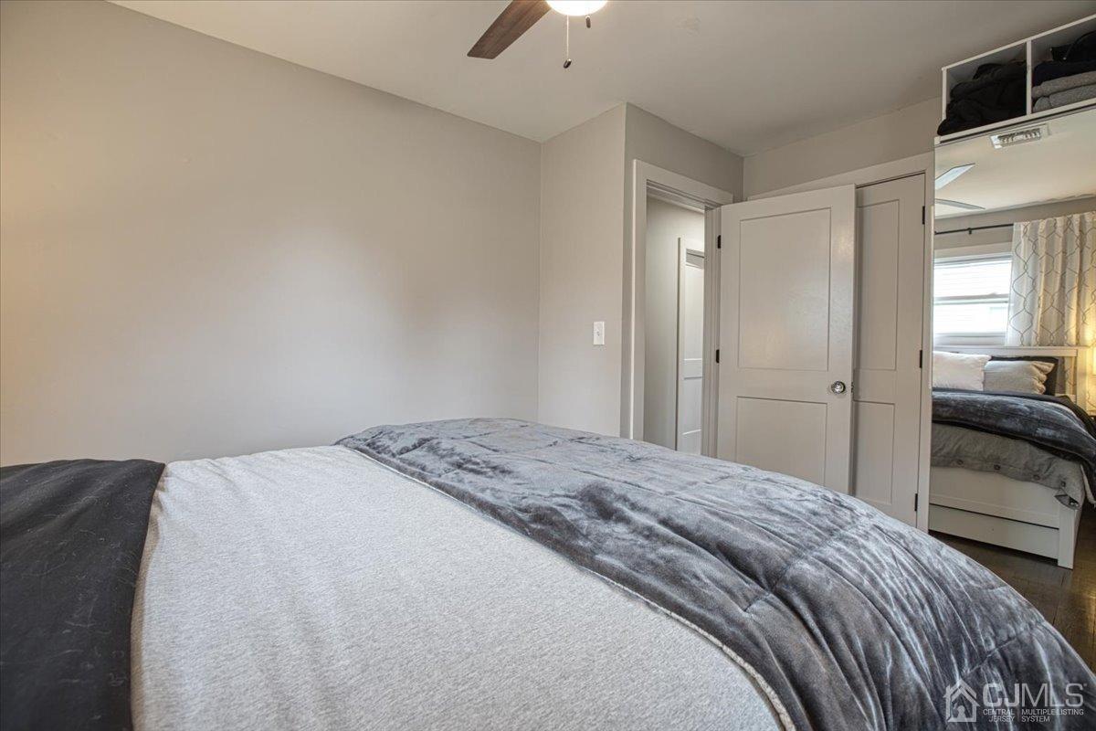 29 Clark Drive Howell, NJ 07731 - Photo 24 of 38 a bedroom with a bed and a chandelier