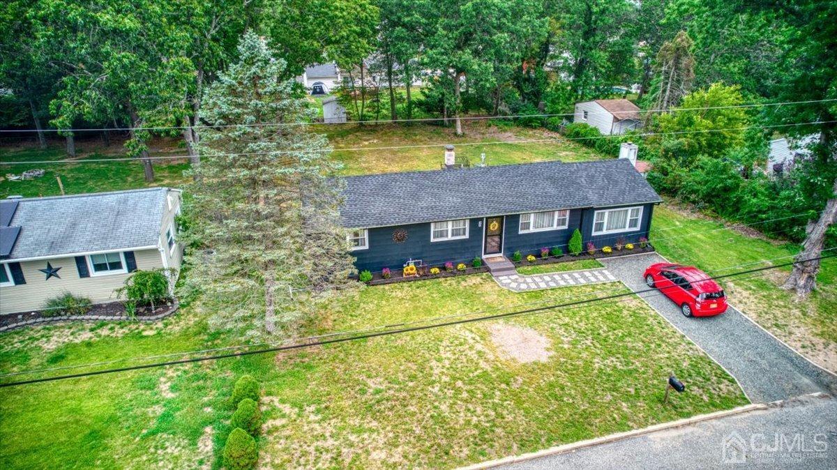 29 Clark Drive Howell, NJ 07731 - Photo 32 of 38 a aerial view of a house with table and chairs and potted plants