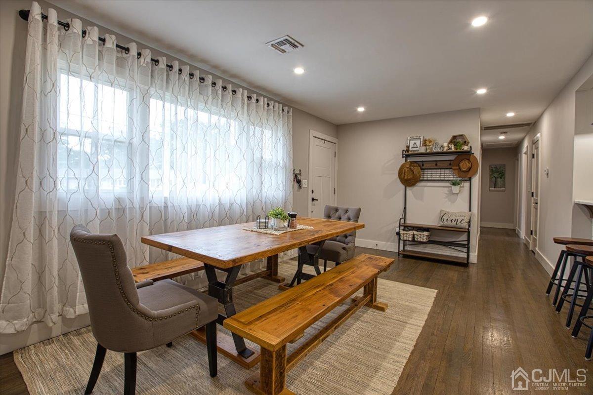 29 Clark Drive Howell, NJ 07731 - Photo 5 of 38 a living room with furniture a rug and a chandelier