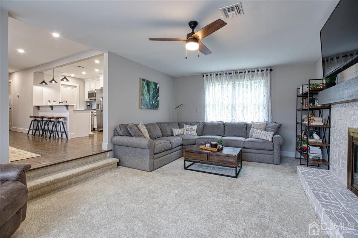 29 Clark Drive Howell, NJ 07731 - Photo 6 of 38 a living room with furniture and a flat screen tv