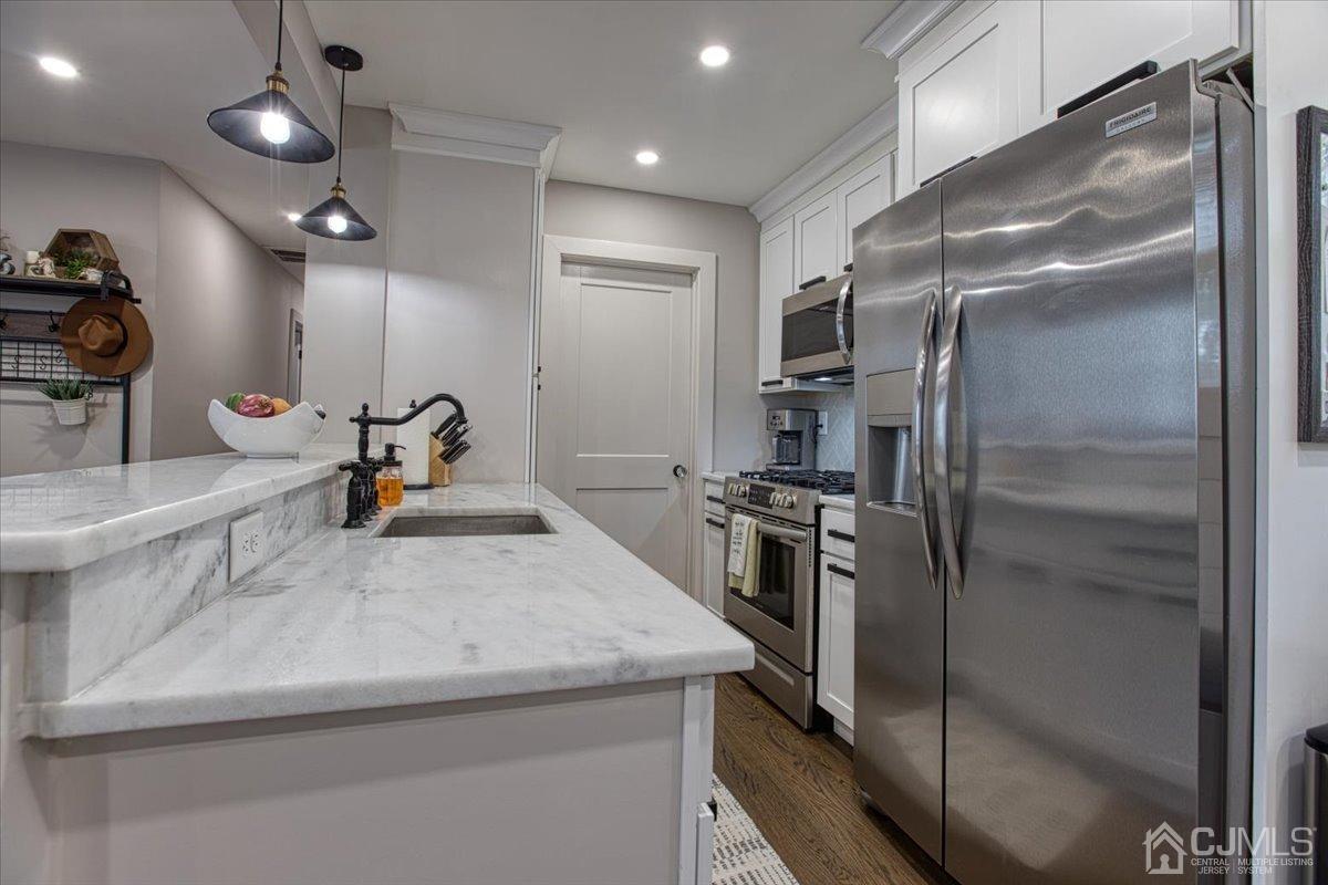 29 Clark Drive Howell, NJ 07731 - Photo 9 of 38 a kitchen with stainless steel appliances granite countertop a sink and a refrigerator
