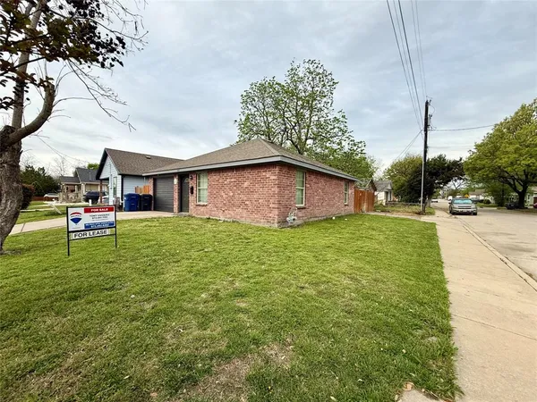 a front view of house with yard and trees