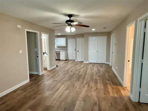 a view of empty room with wooden floor