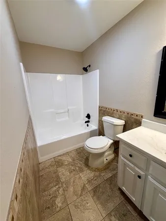 a bathroom with a toilet a sink and bathtub