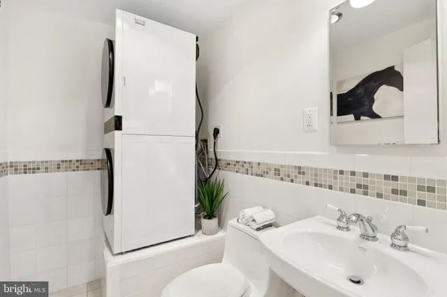 a bathroom with a sink toilet and mirror