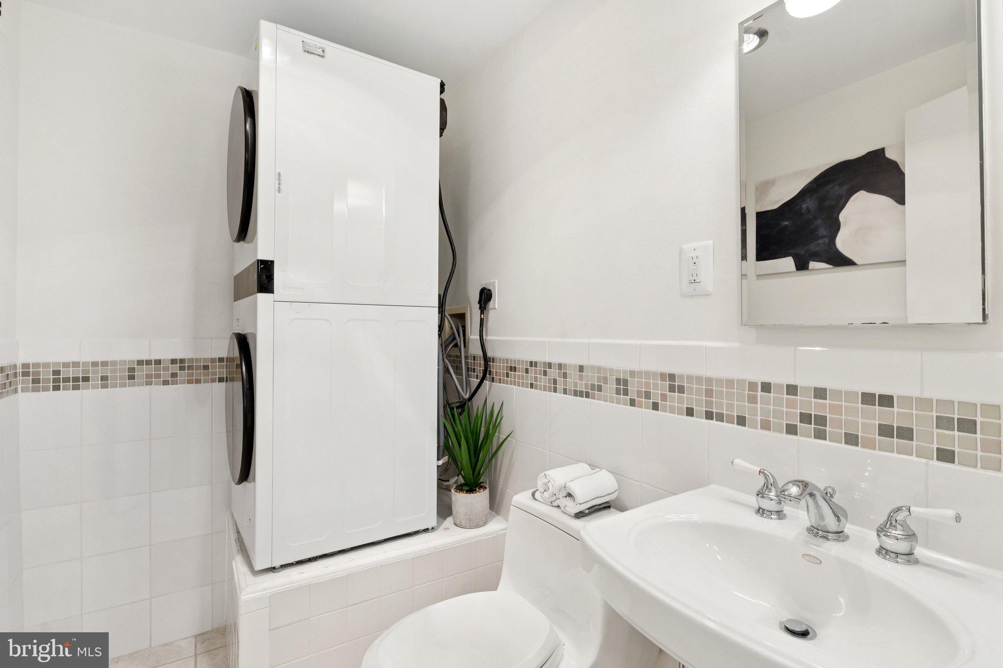 1880 Columbia Road Northwest, Unit 204 Washington, DC 20009 - Photo 11 of 23 a bathroom with a sink toilet and mirror