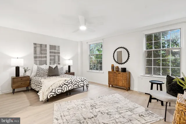 a bedroom with a bed chair and window