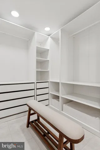 a bathroom with a granite countertop sink a mirror and a shower
