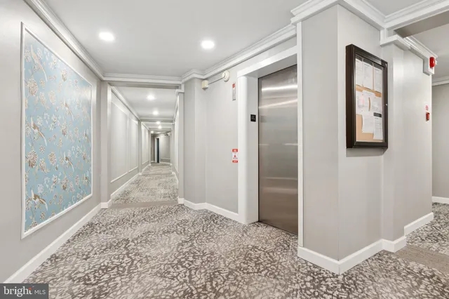 a very nice looking dining room with chandelier
