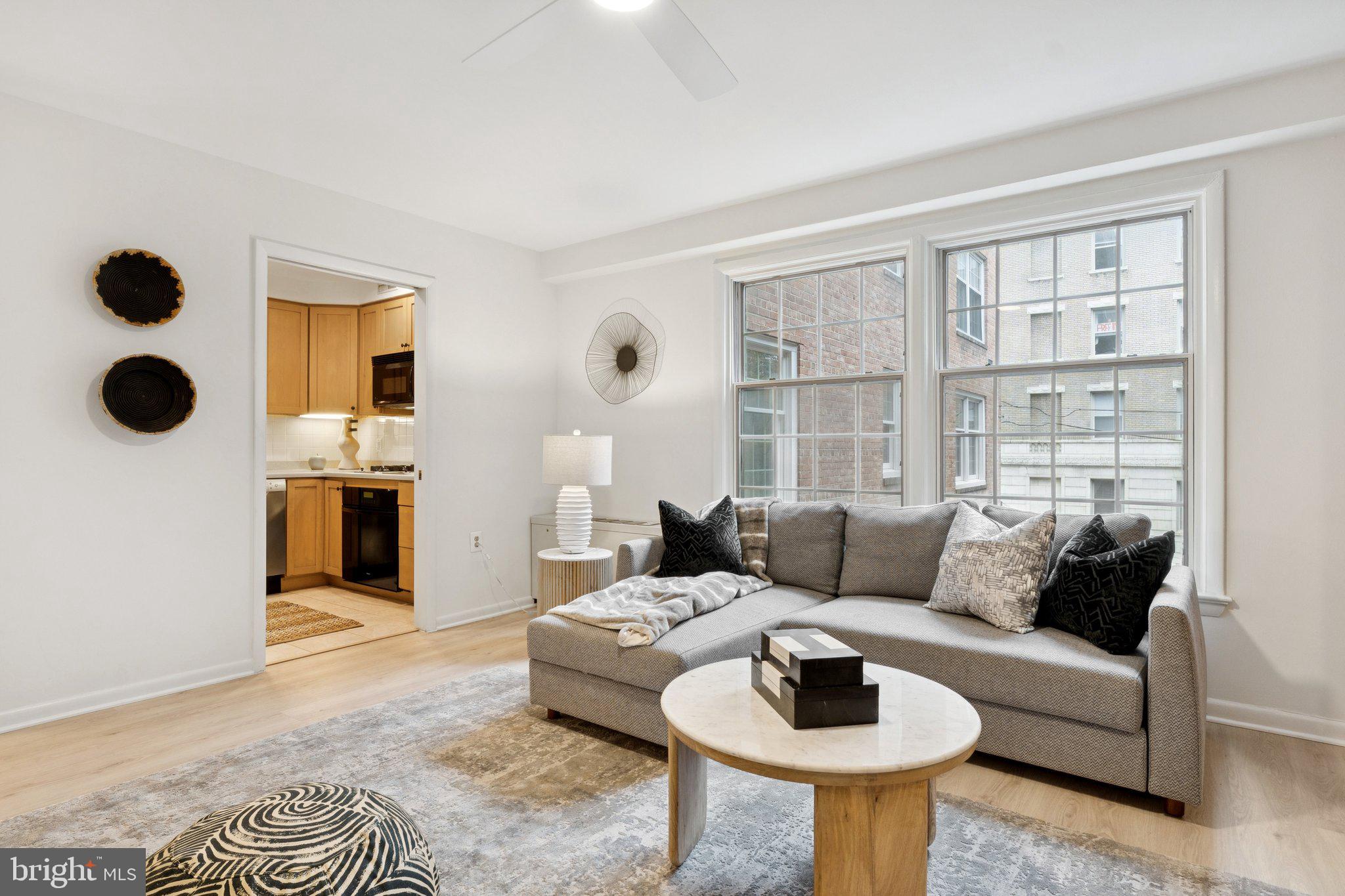 1880 Columbia Road Northwest, Unit 204 Washington, DC 20009 - Photo 4 of 23 a living room with furniture and a large window