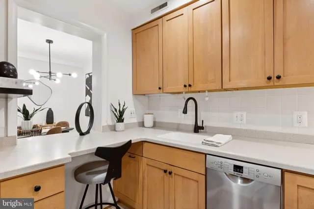 a kitchen with a sink cabinets and appliances