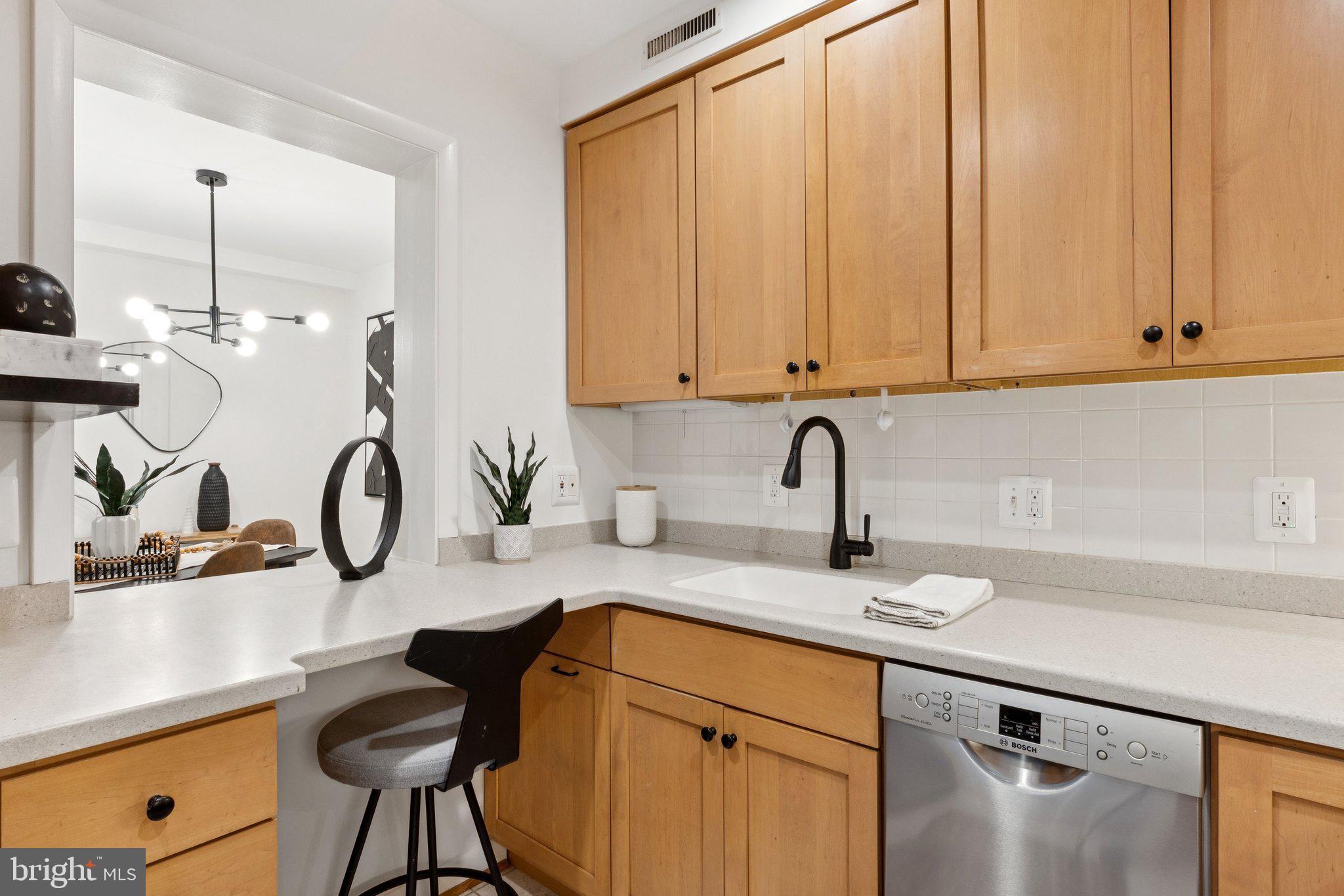 1880 Columbia Road Northwest, Unit 204 Washington, DC 20009 - Photo 6 of 23 a kitchen with a sink cabinets and appliances