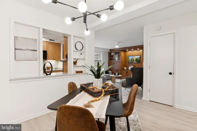 a view of a dining room with furniture and a chandelier