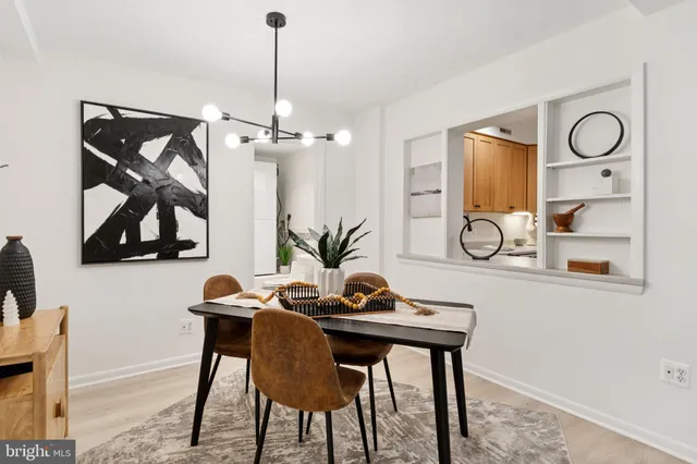 a view of a dining room with furniture and chandelier