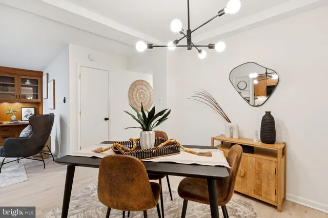 a view of a dining room with furniture and chandelier