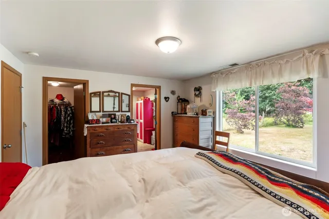 a bedroom with bed and a closet