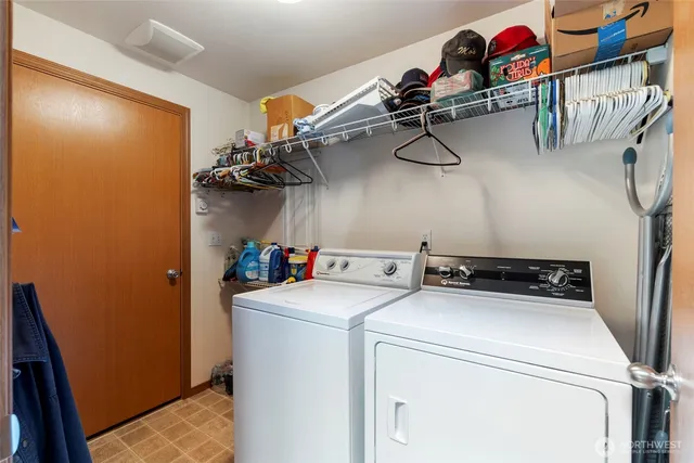 a view of a house with a yard and large tree