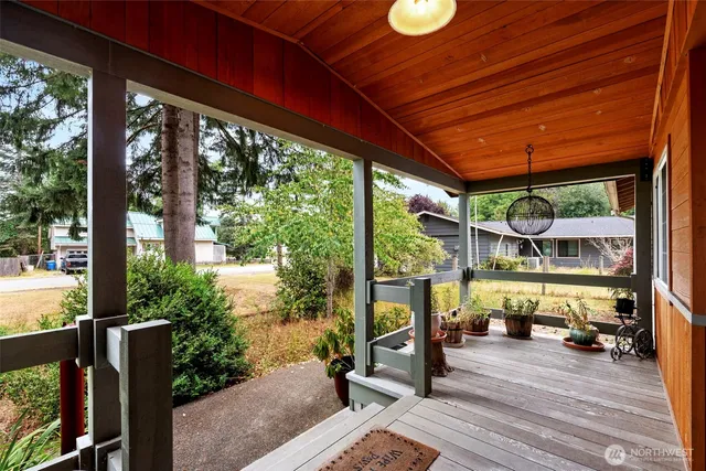 a sitting area with furniture and wooden floor